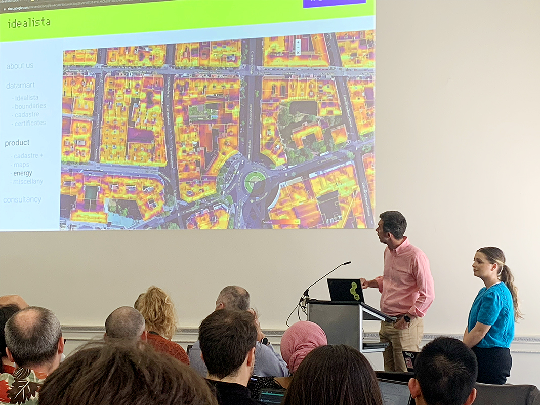 A photograph of two people presenting a map in a seminar